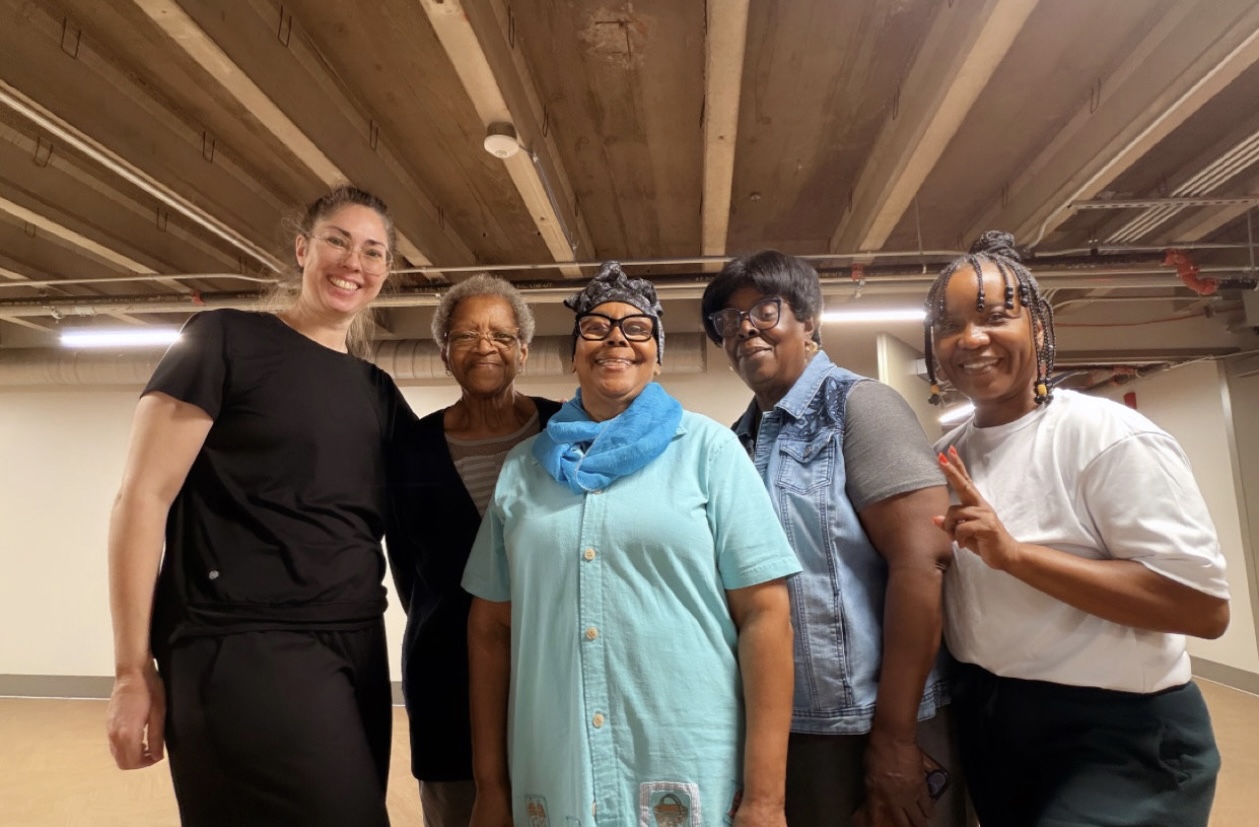 Five smiling members of the community together at the first line dance session